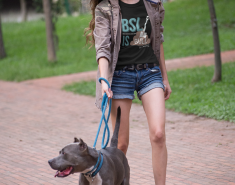 pretty-woman-walking-the-dog-wearing-a-t-shirt-mockup-at-the-park-a17354